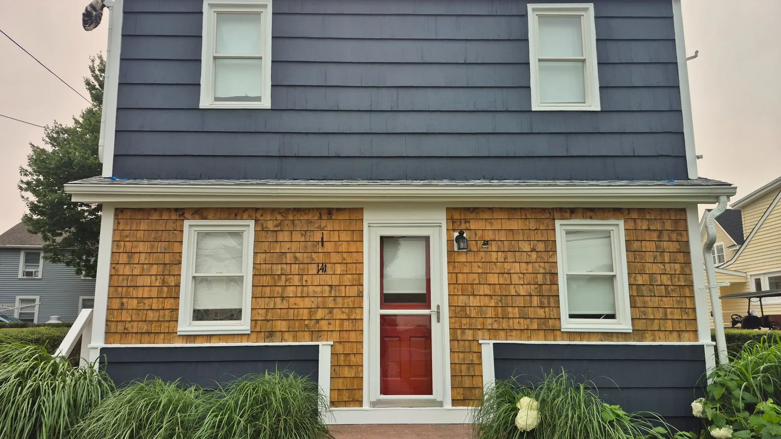 A Connecticut shingled home freshly repainted slate blue with white trim